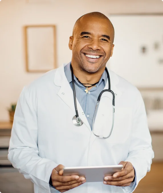 smiling doctor with a stethoscope around his neck